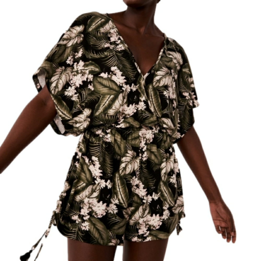 Tropical floral romper with tassles pink flower palm fronds and ferns